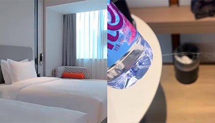 女子饮用酒店内的矿泉水后